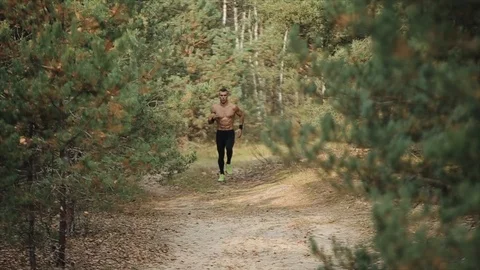 Young muscular man running with naked to... | Stock Video | Pond5