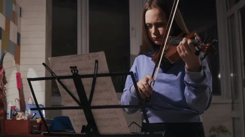 Young Musician Focused on Notes During Home Practice Video stock 312041228