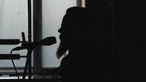Young musician singing into microphone while recording new song at home Stock Footage 133507140