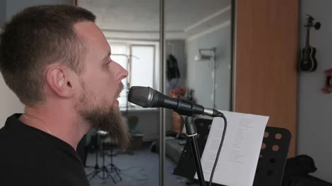 Young musician singing into microphone while recording new song at home Stock Footage 133508271
