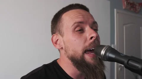 Young musician singing into microphone while recording new song at home Stock Footage 133510179
