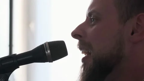 Young musician singing into microphone while recording new song at home Stock Footage 133511702