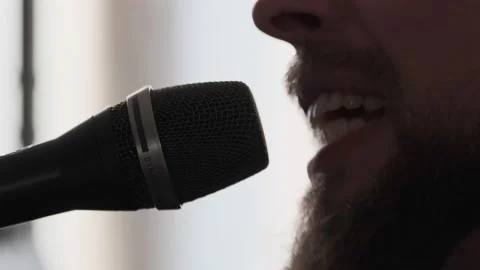 Young musician singing into microphone while recording new song at home Stock Footage 133514594