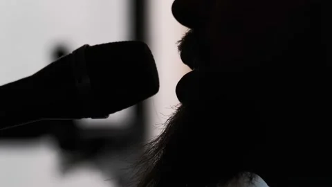 Young musician singing into microphone while recording new song at home Stock Footage 133515375