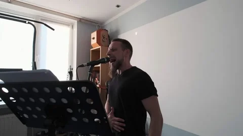 Young musician singing into microphone while recording new song at home Stock Footage 133523615