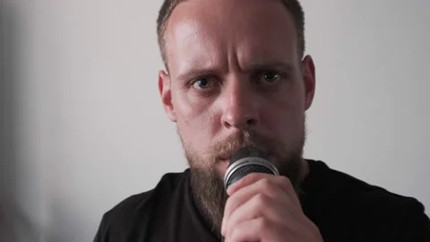 Young musician singing into microphone while recording new song at home Stock Footage 133525382