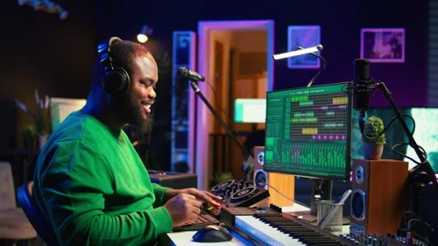 Young musician twisting knobs and mixing tunes with a console 스톡 동영상 281449035