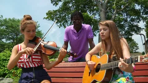 Young Musicians Practicing on Park Bench Stock Footage 8914324