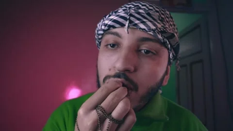 A young Muslim man eats dates for breakfast in Ramadan Stock Footage 299574486