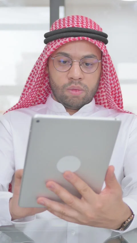 Young Muslim Man Using Digital Tablet for Work, vertical video Vídeo Stock 325568245