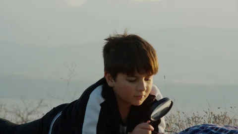 Young nerd exploring a plant in nature 스톡 동영상 105292689