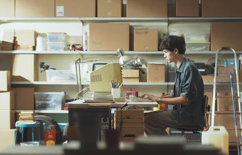 Young nerd guy working with a vintage computer 스톡 사진
