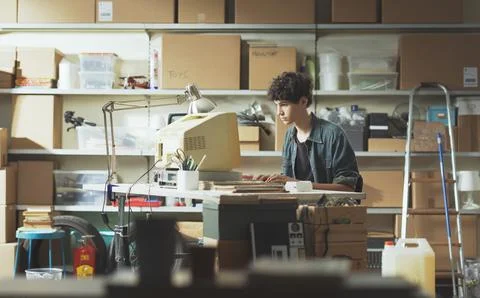 Young nerd guy working with a vintage computer 스톡 사진