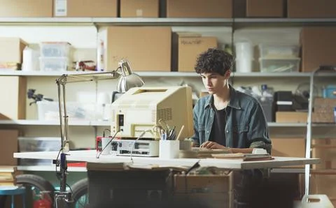 Young nerd guy working with a vintage computer 스톡 사진
