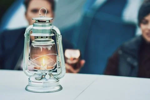 Young nice couple having fun on camping with kerosene lamp Stock Photos