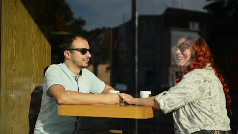 Young Nice Couple Sitting In Cafe Wrapped In Cozy Blanket Drinking Tea. Love Stock Footage 107167366