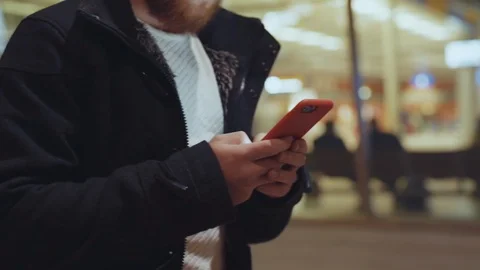 Young nice-looking man browsing application on smartphone exploring social media Stock Footage 117429744