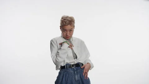 Young non-binary Asian person gestures who me? Video stock 153503544