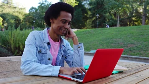 Young non-binary gender student person working on laptop at college campus. Stock Footage 287581655