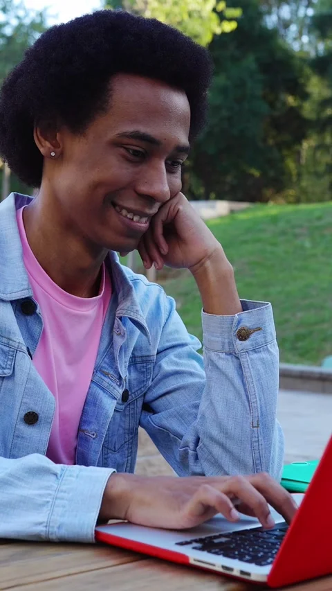 Young non-binary gender student person working on laptop at college campus. Stock Footage 312265004