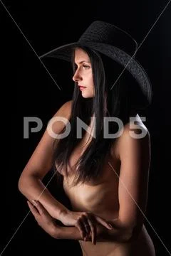 Photograph: Young nude woman with make up. Model with hat. Naked girl