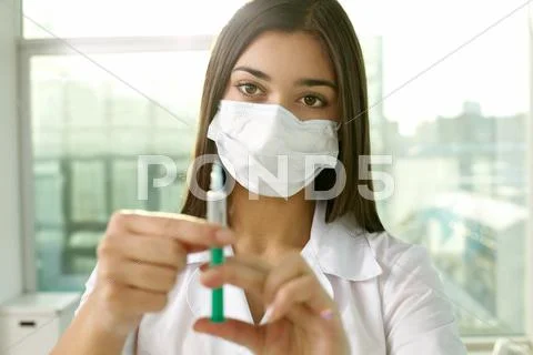 Young nurse filling the syringe Stock Photos