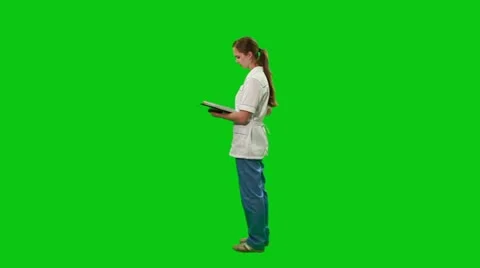 Young nurse moves around with a report. Green screen. Stock Footage
