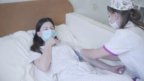 A young nurse puts a drip Stock Footage 147024010