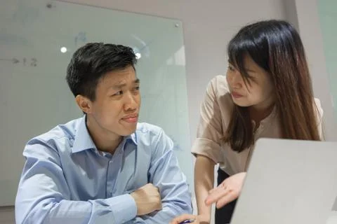 Young office lady asking workmate for help Stock Photos