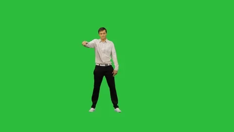 Young office man dancing locking on a Green Screen, Chroma Key. Stock Footage