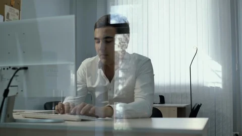 Young office man worker sitting with hands on head in front of computer Stock Footage 111940340
