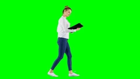 Young Office Worker Checks Notes Drinking Coffee and Walking on Green Screen Video stock 124607052