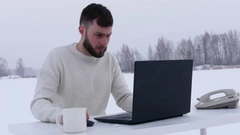 Young office worker in the field. Office manager in the snow. Stock Footage 148432396