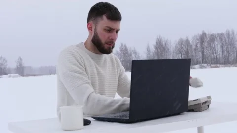 Young office worker in the field. Office manager in the snow. Stock Footage 148432755