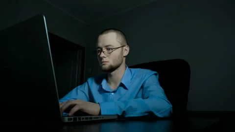 Young office worker in glasses typeing on a laptop Stock Footage 88995833