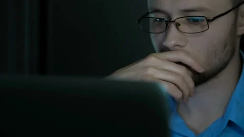 Young office worker in glasses typeing on a laptop Stock Footage 88996033