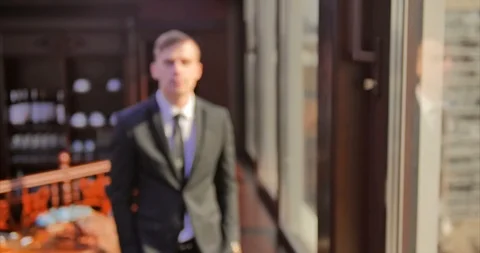 A young office worker. A man in a gray suit walks along a window in an expensive Stock Footage 113106980