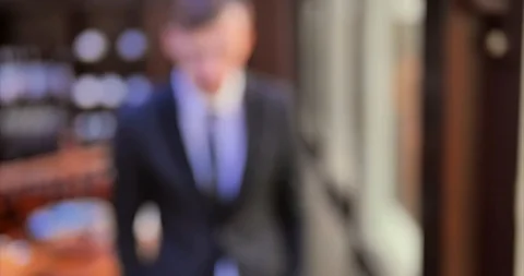 A young office worker. A man in a gray suit walks along a window in an expensive Stock Footage 113107217
