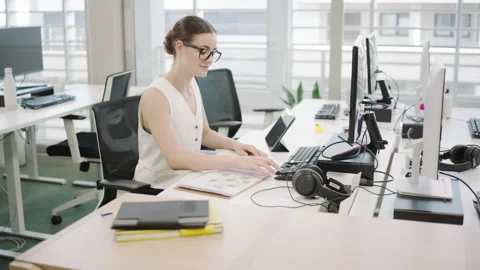 Young Office Worker in a Modern Workspace with Keywords Related to Business and Stock Footage 278490223