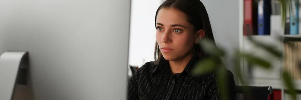 Young office worker stare at computer screen, search information online Stock Photos
