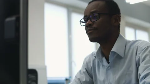 Young office worker using his laptop at work Stock Footage 68307269