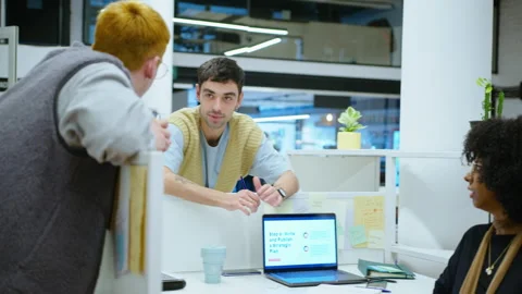 Young Office Workers Chatting Over Cubicle Wall during Workday Stock Footage 243990654