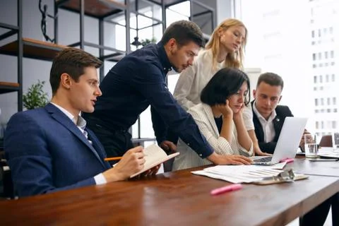 Young office workers having some problems, trying to overcome them Stock Photos