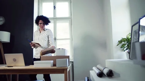 Young online shop owner checking delivery and parcels Stock Footage 114127782