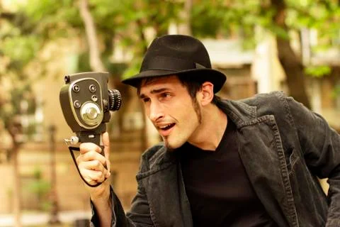 Young operator looks at the old camera Stock Photos