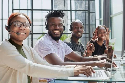 Young operators sitting at the workplace posing for the camera Stock Photos
