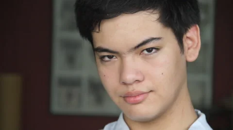 Young Oriental boy smiles to camera Stock Footage 40498780