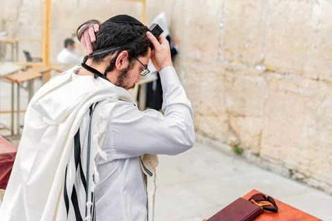 A young Orthodox Jew with a tallit shawl and phylacteries (tefilin) on left a Stock Photos