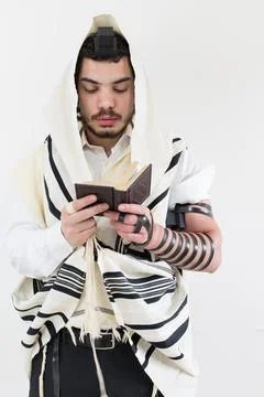 Young Orthodox Jewish man in shawl (tallit) and phylacteries (tefilin), prayi Stock Photos