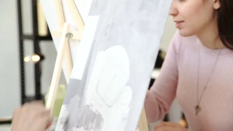 A young painter busy with drawing at his workplace 4k 20s Stock Footage 72852818